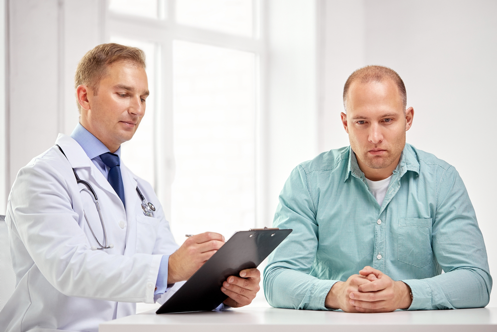 male doctor with clipboard and patient meeting